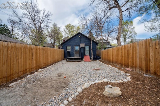 519 W Bijou St, Colorado Springs, CO 80905 - back of property featuring a fenced backyard and driveway