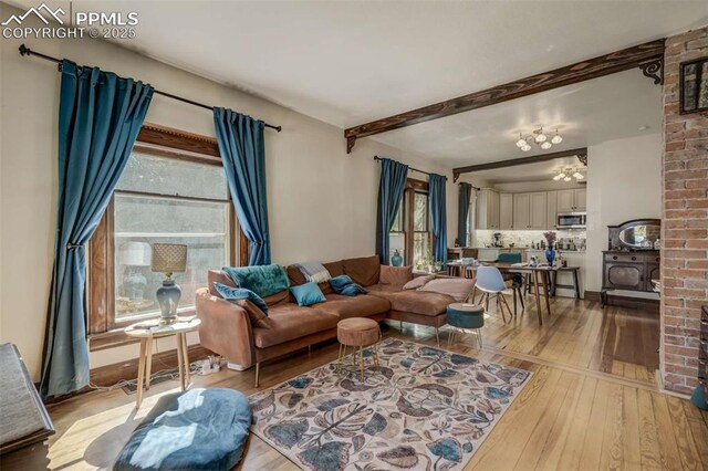 519 W Bijou St, Colorado Springs, CO 80905 - living area with light wood finished floors, beam ceiling, and a chandelier