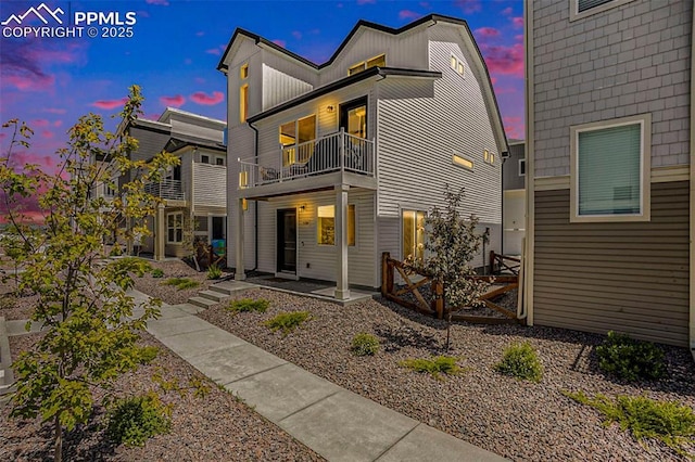 rear view of property featuring a balcony