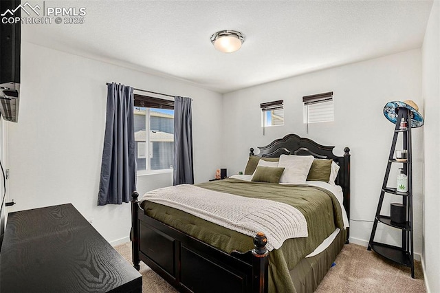 bedroom featuring baseboards, light colored carpet, and multiple windows