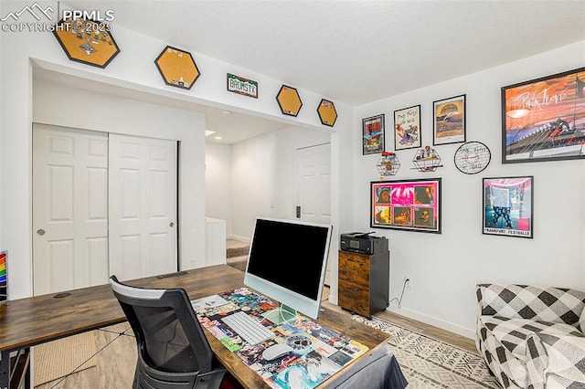 office featuring baseboards and wood finished floors