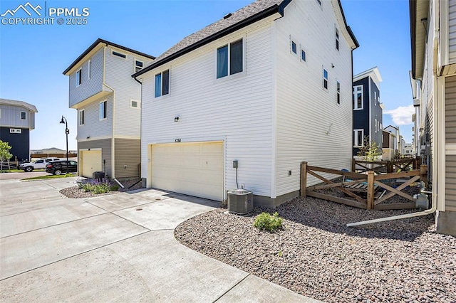 view of property exterior featuring a garage and driveway