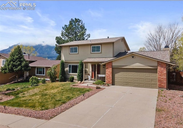 840 Quail Lake Cir, Colorado Springs, CO 80906 - traditional-style home with concrete driveway, a front yard, an attached garage, fence, and brick siding