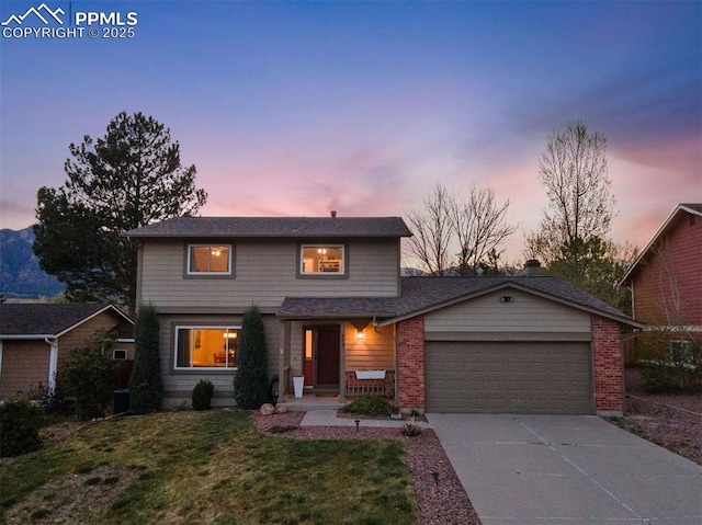 840 Quail Lake Cir, Colorado Springs, CO 80906 - traditional-style house featuring driveway, a yard, a garage, and brick siding