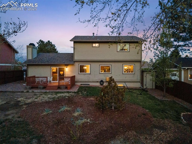 840 Quail Lake Cir, Colorado Springs, CO 80906 - back of house with a lawn, a deck, a fenced backyard, and a chimney