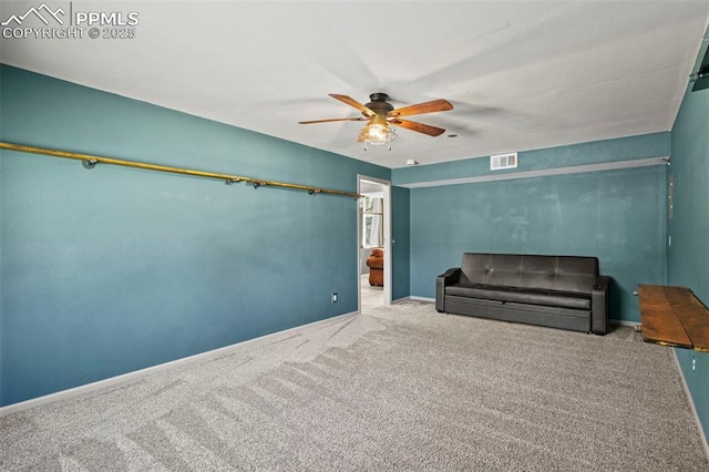 unfurnished room featuring carpet floors, visible vents, baseboards, and ceiling fan