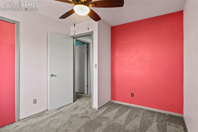 unfurnished bedroom with ceiling fan, a textured ceiling, and carpet