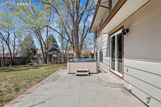 view of patio featuring a fenced backyard and a hot tub