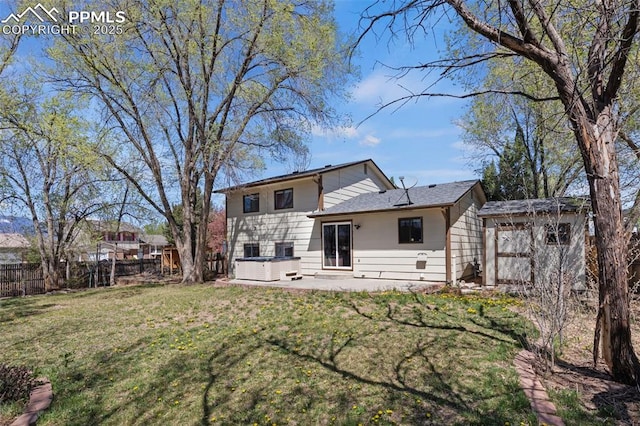 rear view of house with fence, a storage shed, an outbuilding, a lawn, and a hot tub