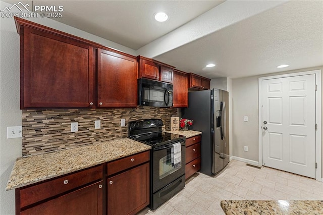 kitchen featuring light tile patterned floors, backsplash, black appliances, and light stone countertops