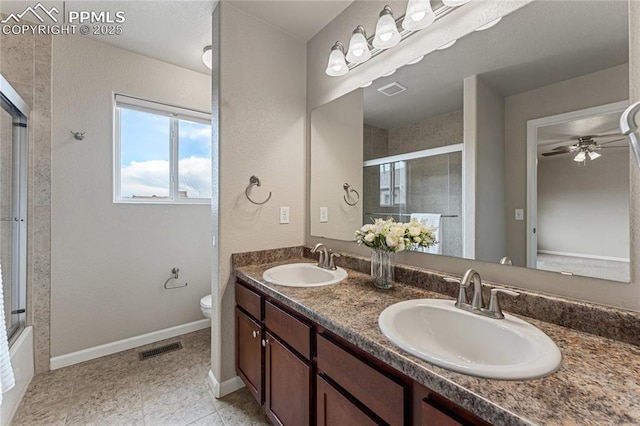 bathroom featuring visible vents, a sink, and a tile shower
