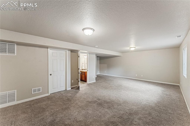 below grade area with carpet flooring and visible vents