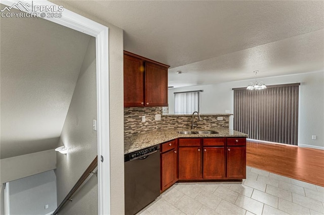 kitchen featuring a sink, light tile patterned floors, a peninsula, a chandelier, and black dishwasher