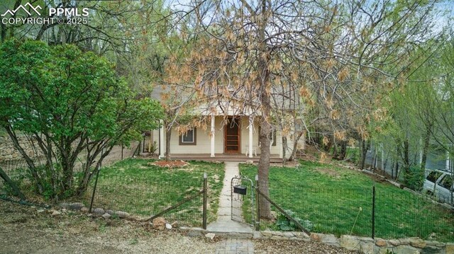 obstructed view of property with covered porch and a front lawn