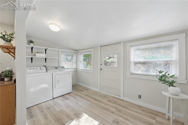laundry room with washer and dryer, light wood finished floors, and baseboards