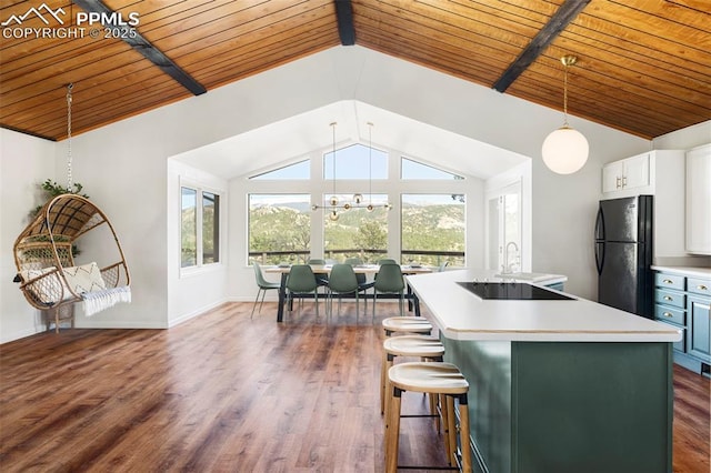 280 Highland Meadows Dr, Florissant, CO 80816 - kitchen with light countertops, plenty of natural light, lofted ceiling with beams, and black appliances