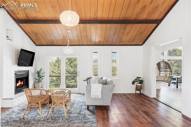 280 Highland Meadows Dr, Florissant, CO 80816 - living area featuring dark wood finished floors, a brick fireplace, vaulted ceiling with beams, and wooden ceiling