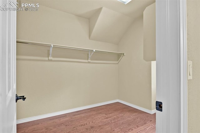 10833 Creede Creek Pt, Colorado Springs, CO 80908 - walk in closet featuring vaulted ceiling and wood finished floors
