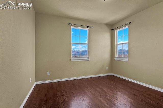 10833 Creede Creek Pt, Colorado Springs, CO 80908 - empty room with baseboards and dark wood finished floors