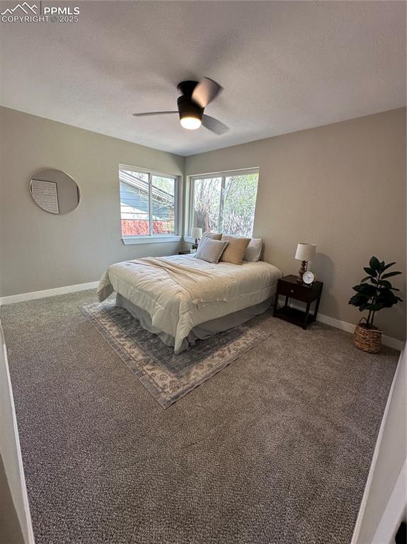 carpeted bedroom with baseboards and ceiling fan
