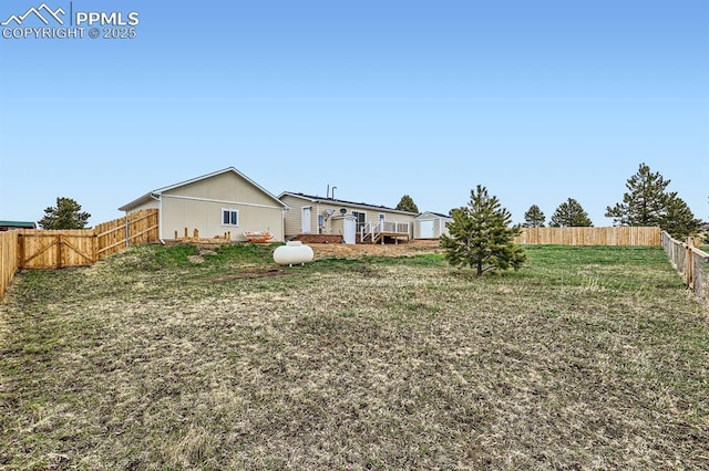 view of yard featuring a fenced backyard, an outbuilding, and a storage shed