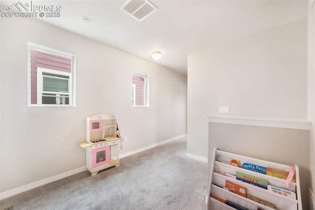 recreation room with baseboards, visible vents, and carpet