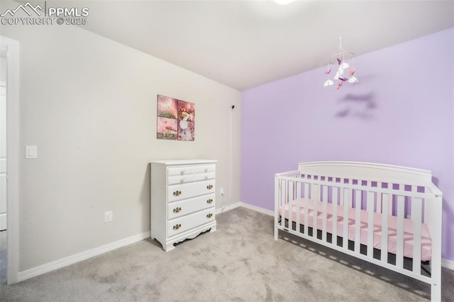 bedroom featuring carpet floors, a nursery area, and baseboards