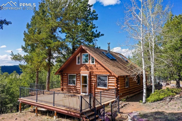 view of front of home featuring log exterior and a wooden deck