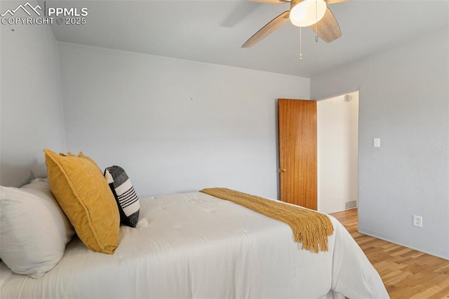 bedroom with wood finished floors and a ceiling fan