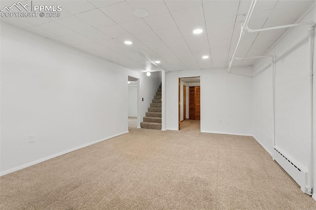 finished basement with baseboard heating, carpet flooring, stairway, and recessed lighting