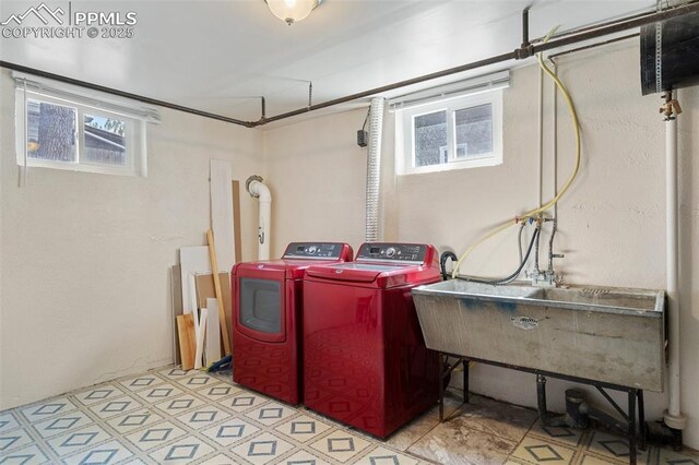 washroom with washing machine and clothes dryer, plenty of natural light, laundry area, and tile patterned floors
