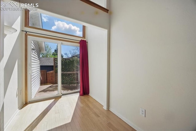 entryway featuring baseboards and wood-type flooring