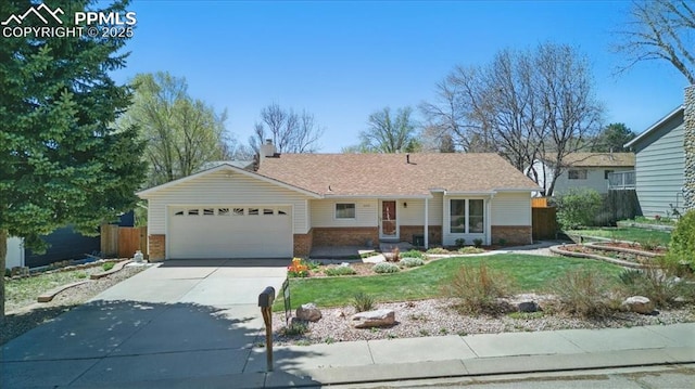 ranch-style home with fence, a front yard, brick siding, an attached garage, and driveway