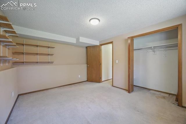 unfurnished bedroom with baseboards, carpet, a closet, and a textured ceiling