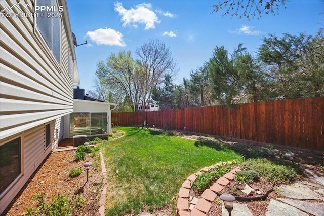 view of yard with a fenced backyard and a sunroom