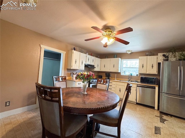 dining room with light floors, baseboards, and a ceiling fan