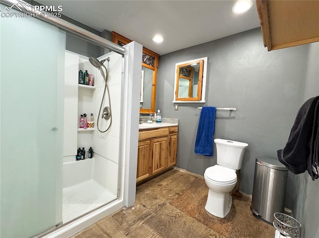 full bathroom featuring toilet, vanity, recessed lighting, and a stall shower
