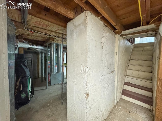 unfinished basement featuring stairs