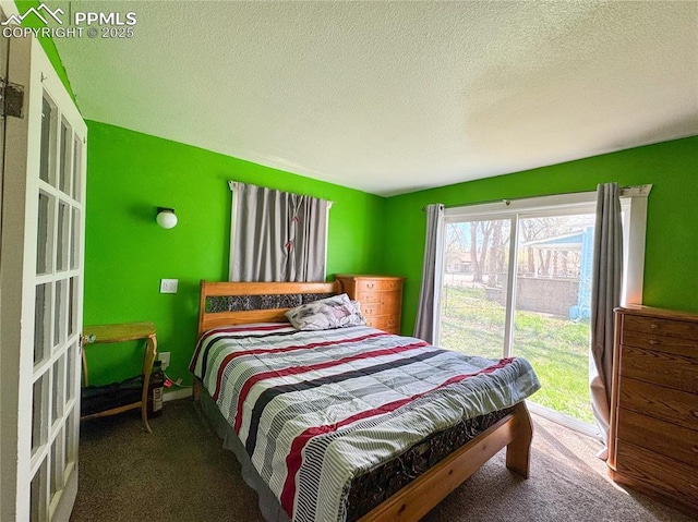 bedroom featuring a textured ceiling and carpet flooring