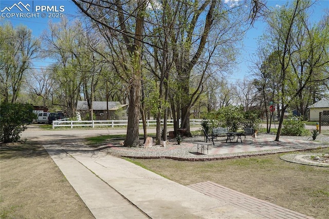 view of home's community featuring fence and driveway