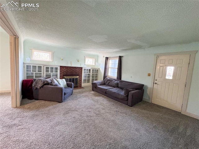 living area featuring carpet floors, a brick fireplace, a textured ceiling, and baseboards