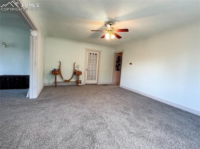spare room featuring a ceiling fan, carpet flooring, and a textured ceiling
