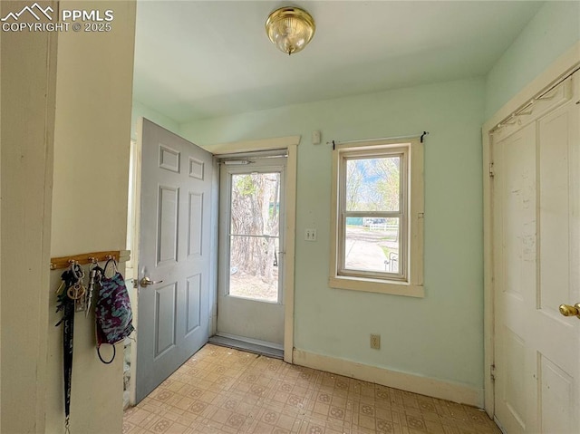 entrance foyer with light floors and baseboards