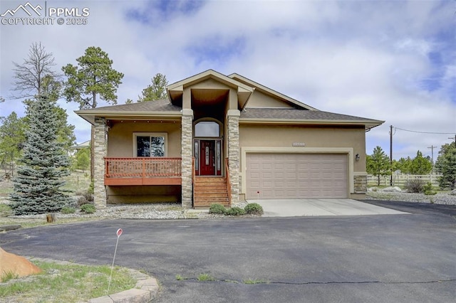 12590 Holmes Rd, Black Forest, CO 80908 - view of front of home with a porch, a garage, aphalt driveway, stone siding, and stucco siding