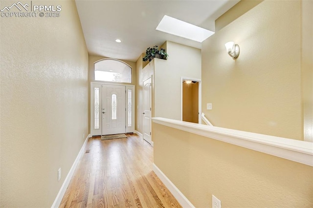 12590 Holmes Rd, Black Forest, CO 80908 - entryway featuring a skylight, visible vents, baseboards, and light wood-style floors