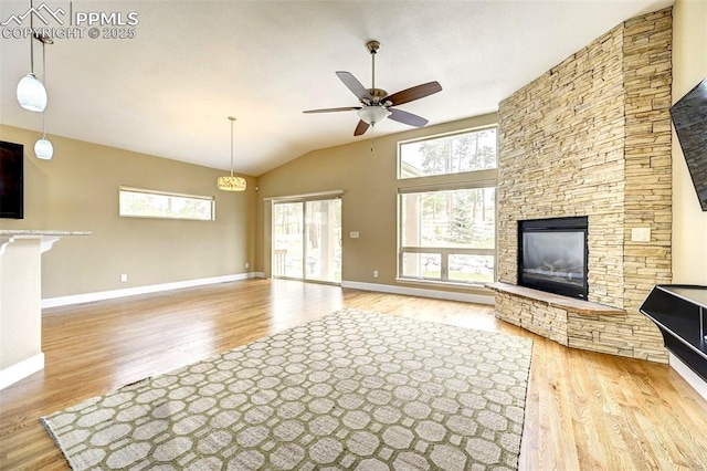 12590 Holmes Rd, Black Forest, CO 80908 - unfurnished living room featuring a ceiling fan, plenty of natural light, wood finished floors, and a fireplace