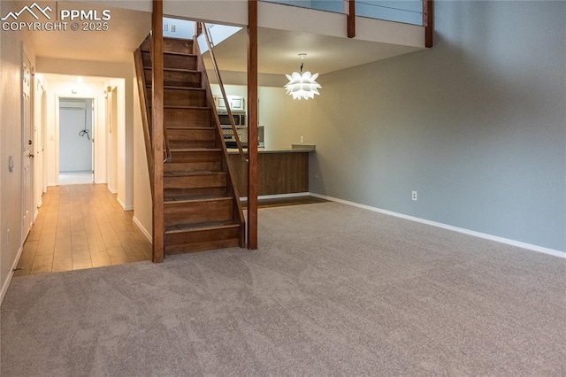 stairway with baseboards and carpet