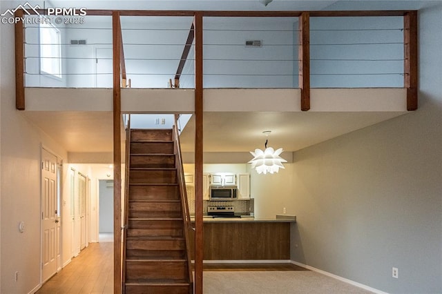 stairway featuring baseboards and wood finished floors