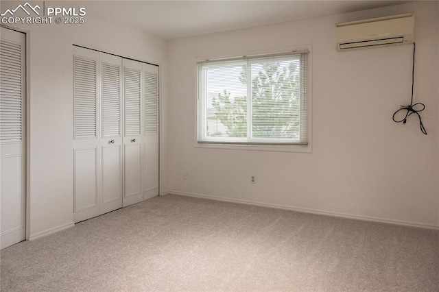 unfurnished bedroom with carpet floors, baseboards, and an AC wall unit