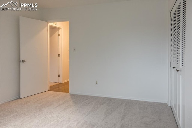 unfurnished bedroom featuring a closet, carpet, and baseboards